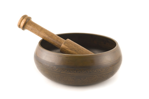A traditional Nepali singing bowl isolated on white.