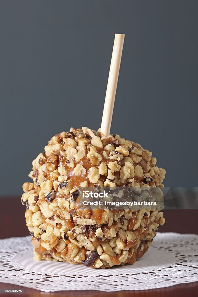 Nutty Apple Candy apple covered in caramel and nuts. Taffy Apple Stock Photo