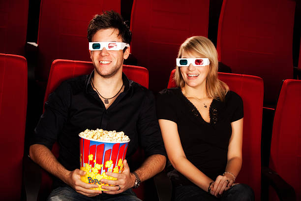 istock guy is watching a 3D movie with his girlfriend 182480639