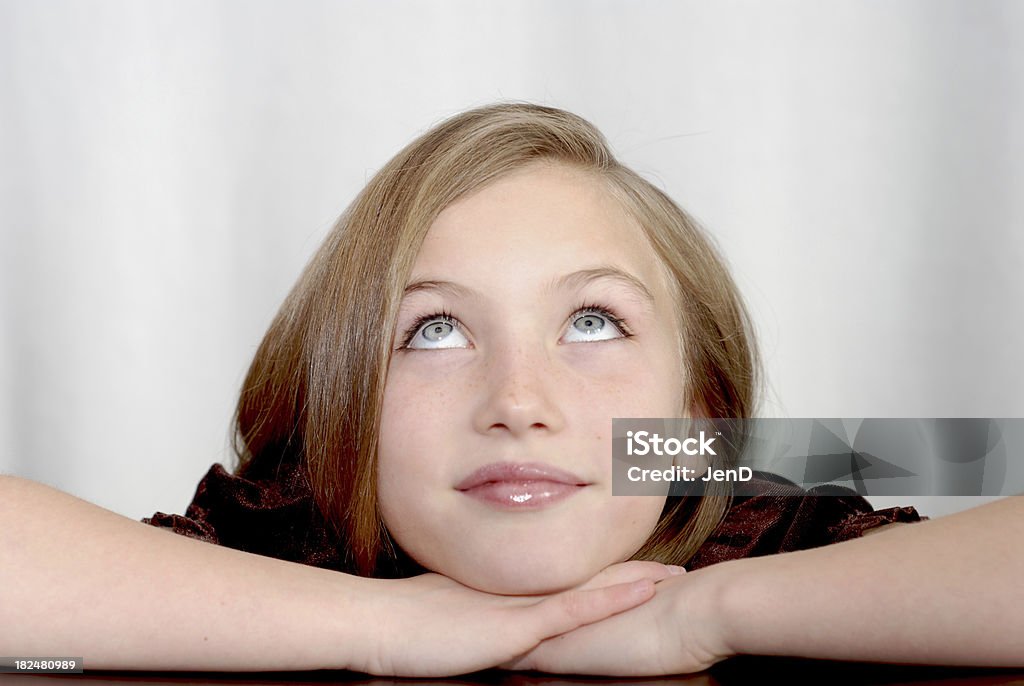 Daydream "Little girl looking up in thought, daydream" Beautiful People Stock Photo