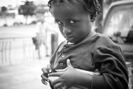 An African boy looking sadly at the camera.