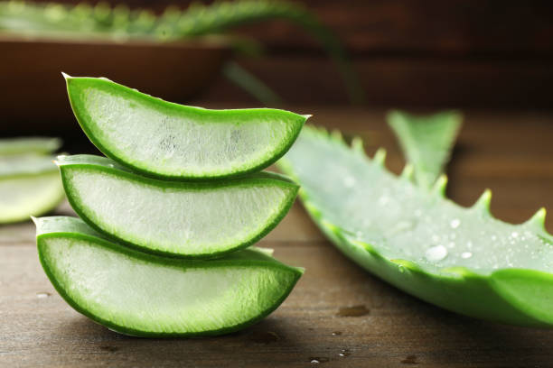 istock Fresh aloe vera pieces on wooden table, closeup 1824813094