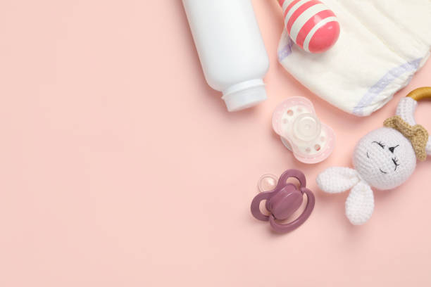 istock Flat lay composition with pacifiers and other baby stuff on pink background. Space for text 1824817490
