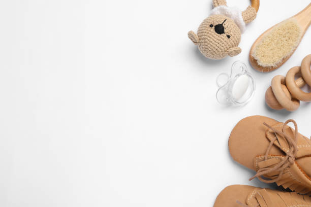 istock Flat lay composition with pacifier and other baby stuff on white background. Space for text 1824818018