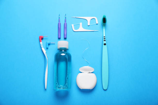istock Dental floss and different teeth care products on light blue background, flat lay 1824818020