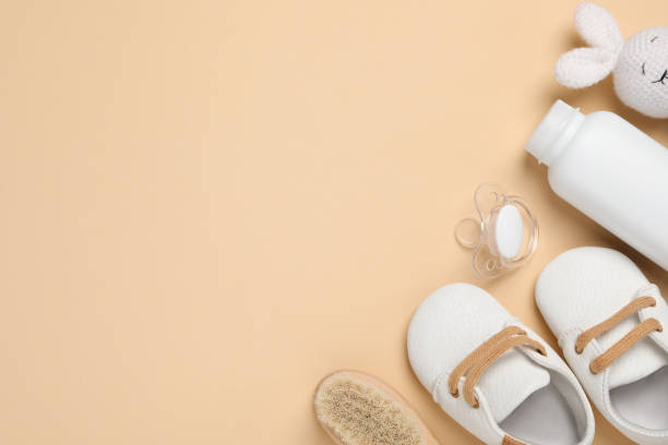 istock Flat lay composition with pacifier and other baby stuff on beige background. Space for text 1824818555