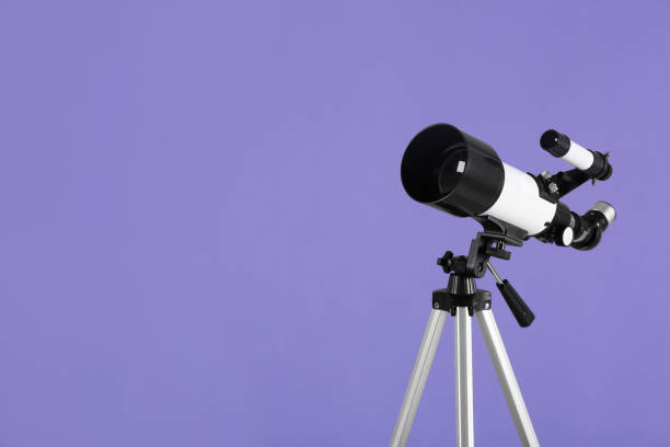 istock Tripod with modern telescope on light purple background, space for text 1824818558