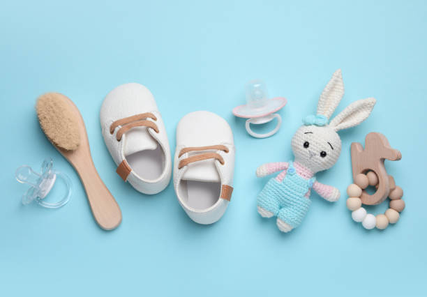 istock Flat lay composition with pacifiers and other baby stuff on light blue background 1824818809