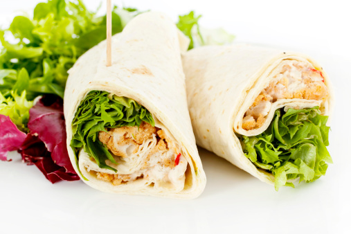Southern fried chicken salad sandwich wrap with side salad