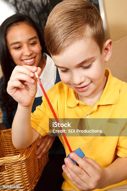 Preschool Boy At Home Playing With String And Blocks Stock Photo - Download Image Now