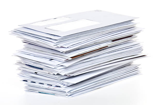 Stack of Unpaid Bills and Envelopes Isolated on White