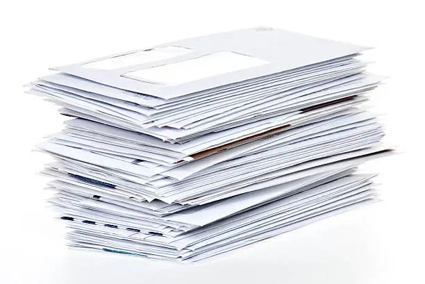 Photo of Stack of Unpaid Bills and Envelopes Isolated on White