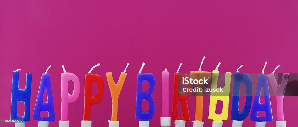 Happy Birthday Colorful Candles, Studio Isolated Colorful Happy Birthday candle letters standing up against pink background. Studio isolated. Birthday Stock Photo