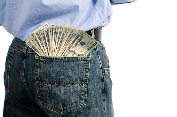 Money in back jeans pocket stock photo