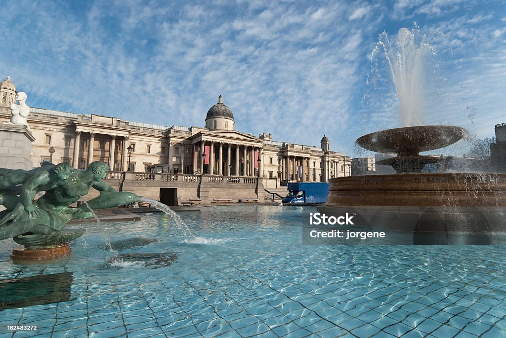 The National Gallery in Trafalgar Square, London The National Gallery, and fountains, at Trafalgar Square in London. A sunny day, with some light clouds. London - England Stock Photo