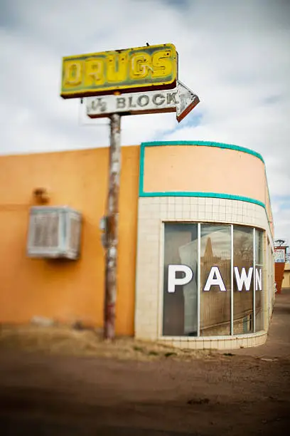 "Old building with a drugstore sign along Route 66 in Tucumcar, New Mexico.  Photographed with a tilt shift lens."