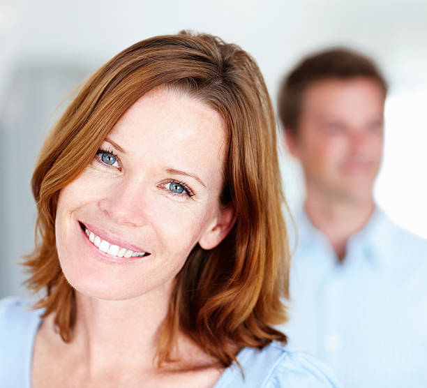 istock Smiling lady with man in the background 182483326