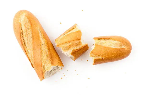 Baguette isolated on white, broken in pieces. Top view.