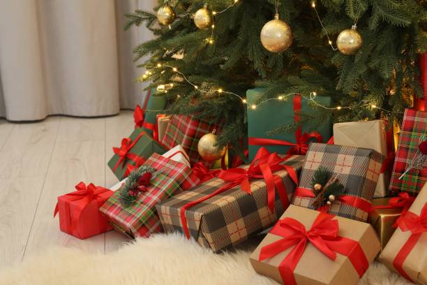 istock Many gift boxes under beautiful Christmas tree in room 1824840852
