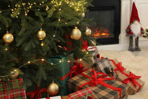 istock Many gift boxes under beautiful Christmas tree in room 1824841357