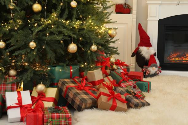 istock Many gift boxes under beautiful Christmas tree in room 1824841358