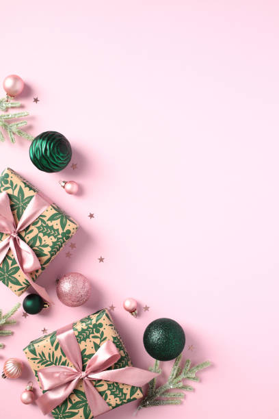 istock Vertical Christmas banner with gift boxes, fir branches, gift boxes, balls on pink background. 1824858800