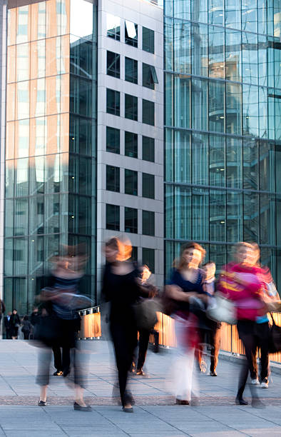 istock Front view of four, motion blurred women walking down sidewalk 182486416