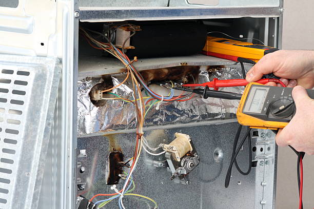 istock Electrician repairing an appliance. 182486526