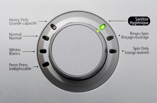 Close up of a modern silver washing machine control button with led. More in my laundry lightbox below...