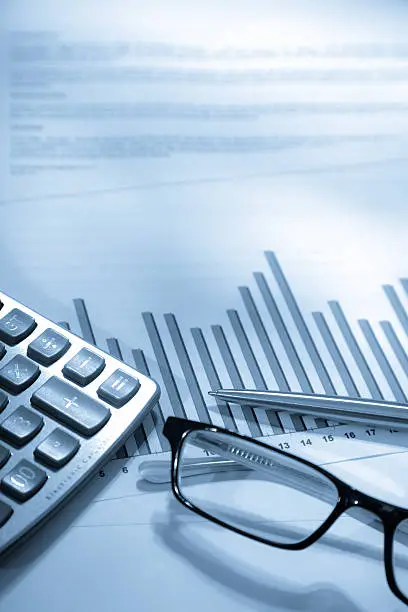 Photo of An analytical graph chart and a pair of spectacles