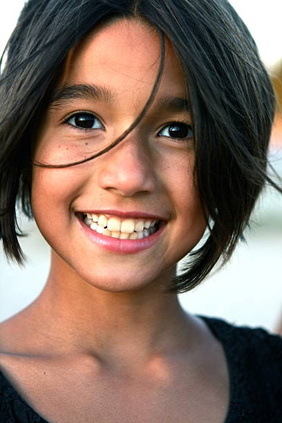 A close up portrait of an 8 year old girl smiling at the camera. Please view many other portraits of children in my portfolio.