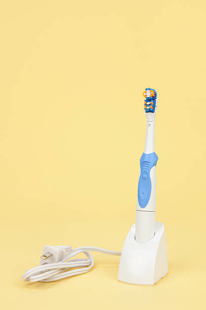 istock Electric Toothbrush on Yellow 182487910