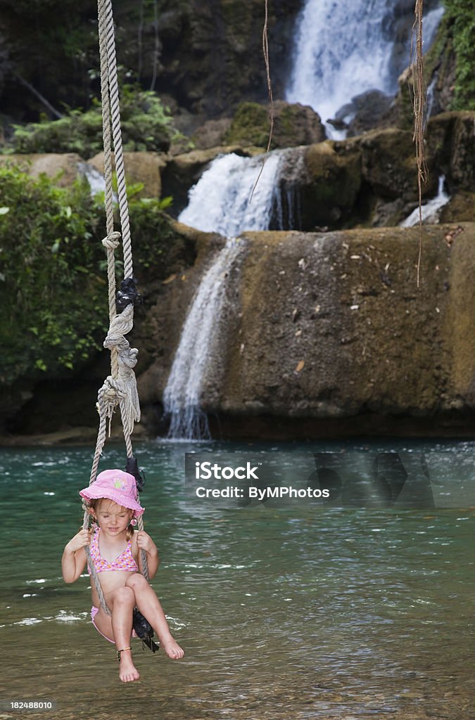 Petite fille dans les Caraïbes avec Chapeau rose se balancer - Photo de Balançoire libre de droits