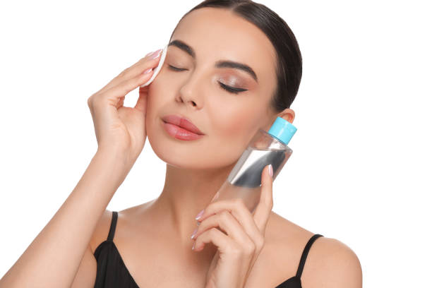 istock Beautiful woman removing makeup with cotton pad on white background 1824881452