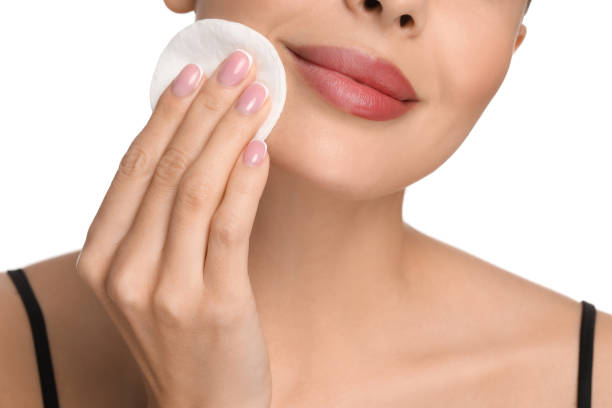 istock Beautiful woman removing makeup with cotton pad on white background, closeup 1824882013