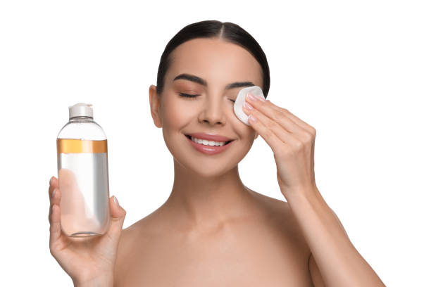 istock Beautiful woman removing makeup with cotton pad on white background 1824883117