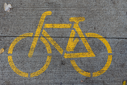 Yellow bike image on the concrete road in the park