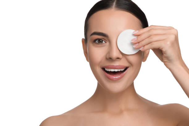 istock Beautiful woman removing makeup with cotton pad on white background 1824883669