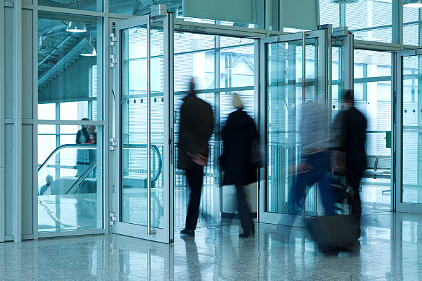 istock Commuters Walking Through Glass Doorway, Blurred Motion 182489258