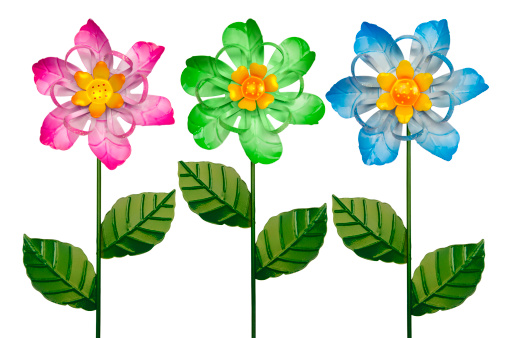 Three Colorful Metal Whirligig Garden Flowers on White Background.