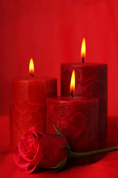 istock Burning candles and red rose 182489702