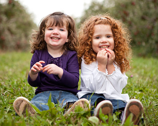 istock Two Happy Sisters Smiling and Laughing Together Outside 182489865