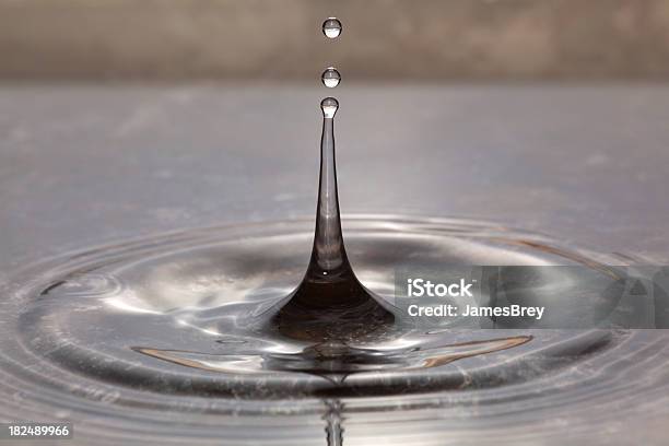 Dripping Rain Water Droplets Splash On Pond Surface Rippling Macro Stock Photo - Download Image Now