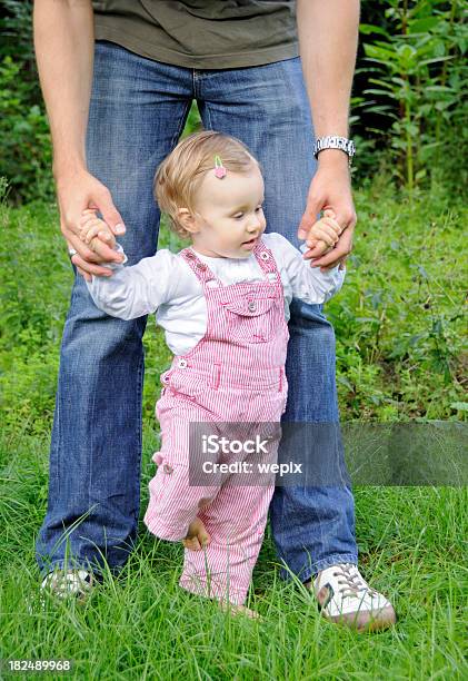 Adorabile Bambina Bambino Imparare A Piedi Padre Mano Giardino - Fotografie stock e altre immagini di 12-23 mesi