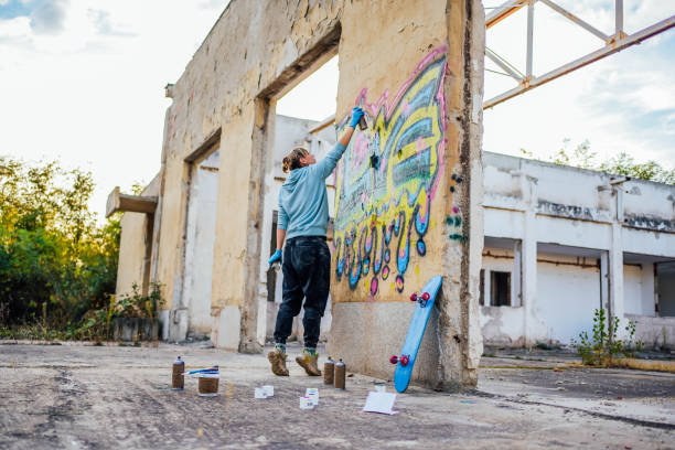 istock Young woman doing graffiti on the wall 1824901072