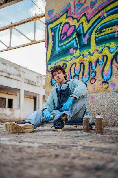 istock Male graffiti artist with spray cans 1824902001