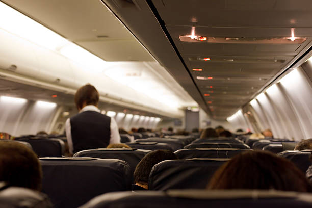istock Plane taken from a seat with a stewardess in the isle 182490427