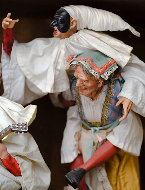 Pulcinella Neapolitan Mask. A traditional representation is Pulicinella on the shoulders of an old woman. This representation is particularly rare.