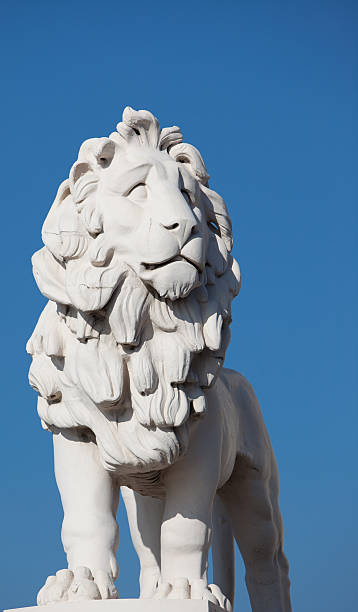 istock Stone Lion Against Blue Sky 182490550