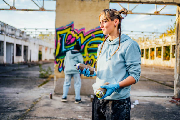 istock Female graffiti artist with spray cans 1824905528